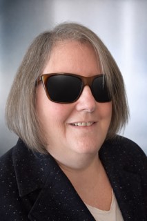 Head and shoulders image of Cindy Williams-Findlay wearing dark glasses.